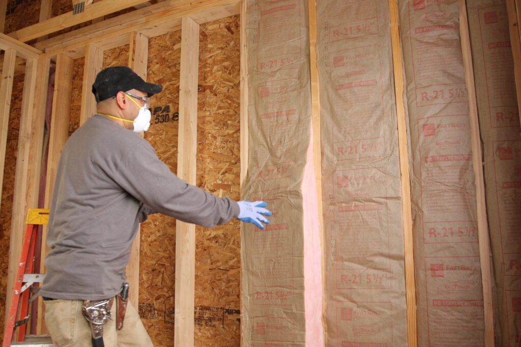 Insulation contractor installing wall insulation