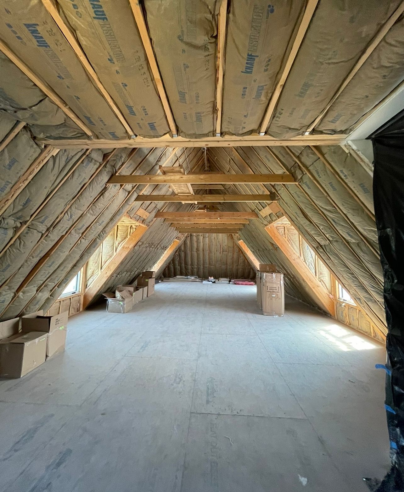 Insulation installed in an unfinished attic.