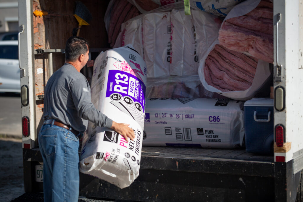Owens Corning R13 Faced Fiberglass Insulation being loaded into a truck